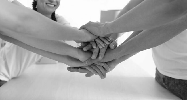 volunteers-smiling-stacking-hands